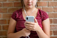 Teen girl listening to music from her phone