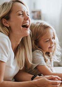 Blonde girl playing on a digital tablet