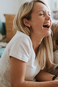 Blonde girl playing on a digital tablet