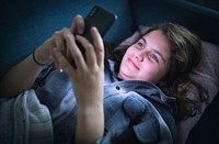 Teen girl texting in the middle of the night