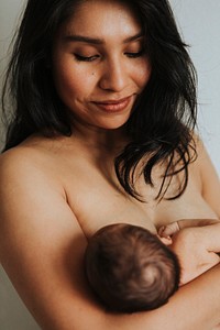 Naked mother holding her newborn baby