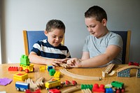 Brothers playing with blocks, trains and cars