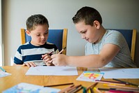 Cute brothers drawing at a table
