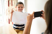 Little boy showing off his drawing