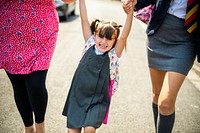 Mother and daughters on the way to school