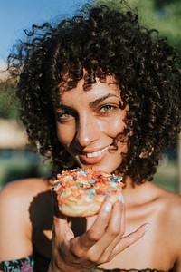 Beautiful woman eating a doughnut