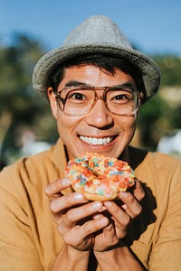 Happy man having a doughnut