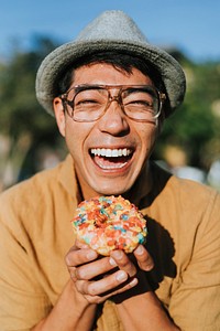 Happy man having a doughnut