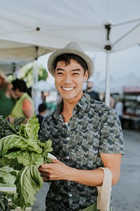 Man buying kale at a farmers market