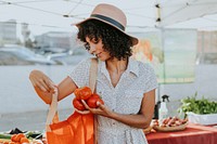 Woman buying tomatoes at a farmers market