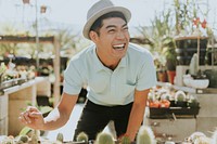 Cheerful man buying a cactus