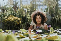 Beautiful woman by a lotus pond