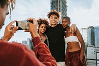 Guy taking a photo of his friends at a rooftop