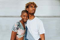 African american couple posing by a wall