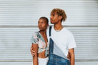 African american couple posing by a wall