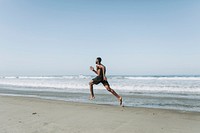 Fit man running at the beach
