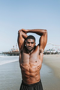 Fit man stretching at the beach