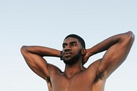 Fit man stretching at the beach