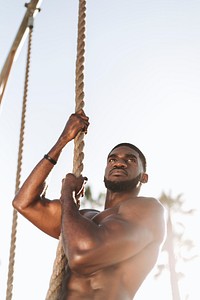 Fit man working out with ropes