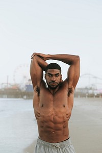 Fit man stretching at the beach