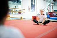 Young gymnast stretching her body