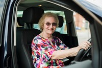 Senior woman sat in the driver seat