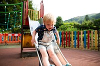 Young boy playing on a slide