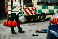 Male paramedic responding to a car accident