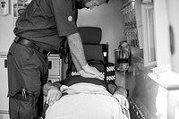 Paramedic resuscitating a patient in an ambulance