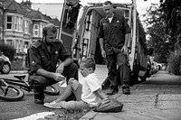Injured boy getting help from paramedics