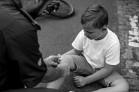 Injured boy getting help from paramedics