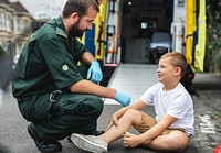 Injured boy getting help from paramedics