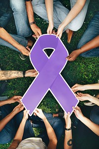 Group of people holding a purple colored ribbon