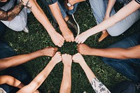 Diverse people doing a fist bump in the park