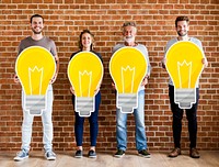 Diverse people holding light bulb icons