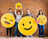 Diverse people holding positive emoticons