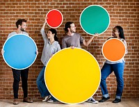 Diverse people holding colorful round boards