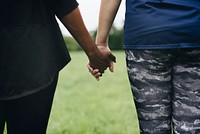 Diverse people holding hands in the park