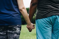 Diverse people holding hands in the park