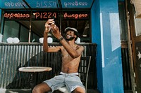 Shirtless man sitting at a cafe