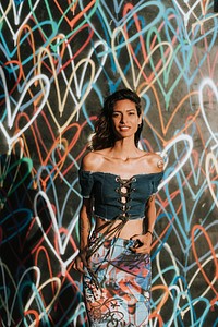 Beautiful model posing against the backdrop featuring the graffiti artwork by James Goldcrown in Los Angeles, USA, 13 July 2018 