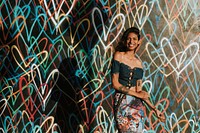 Beautiful model posing against the backdrop featuring the graffiti artwork by James Goldcrown in Los Angeles, USA, 13 July 2018 