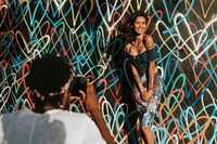 Beautiful model posing by a wall against the backdrop featuring the graffiti artwork by James Goldcrown in Los Angeles, USA, 13 July 2018 