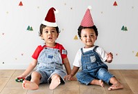 Two little boys sitting on the floor