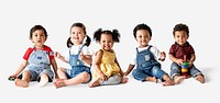 Cute diverse toddlers sitting together on the floor