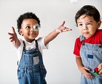 Two cute little boys enjoying playing with bubbles