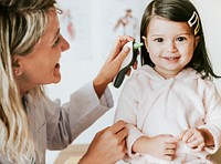 Otolaryngologist checking up on a sweet little girl