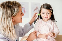 Otolaryngologist checking up on a sweet little girl