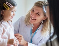 Pediatrician examining a little girl