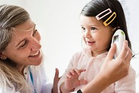 Otolaryngologist checking up on a sweet little girl